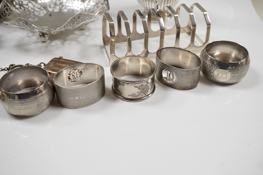 Sundry small silver including an Edwardian oval tea caddy, Hasseler Brothers, London, 1901, 10.4cm, a pierced bonbon dish, a late Victorian cream jug, five napkin rings including two pairs, a seven bar toast rack, a dama
